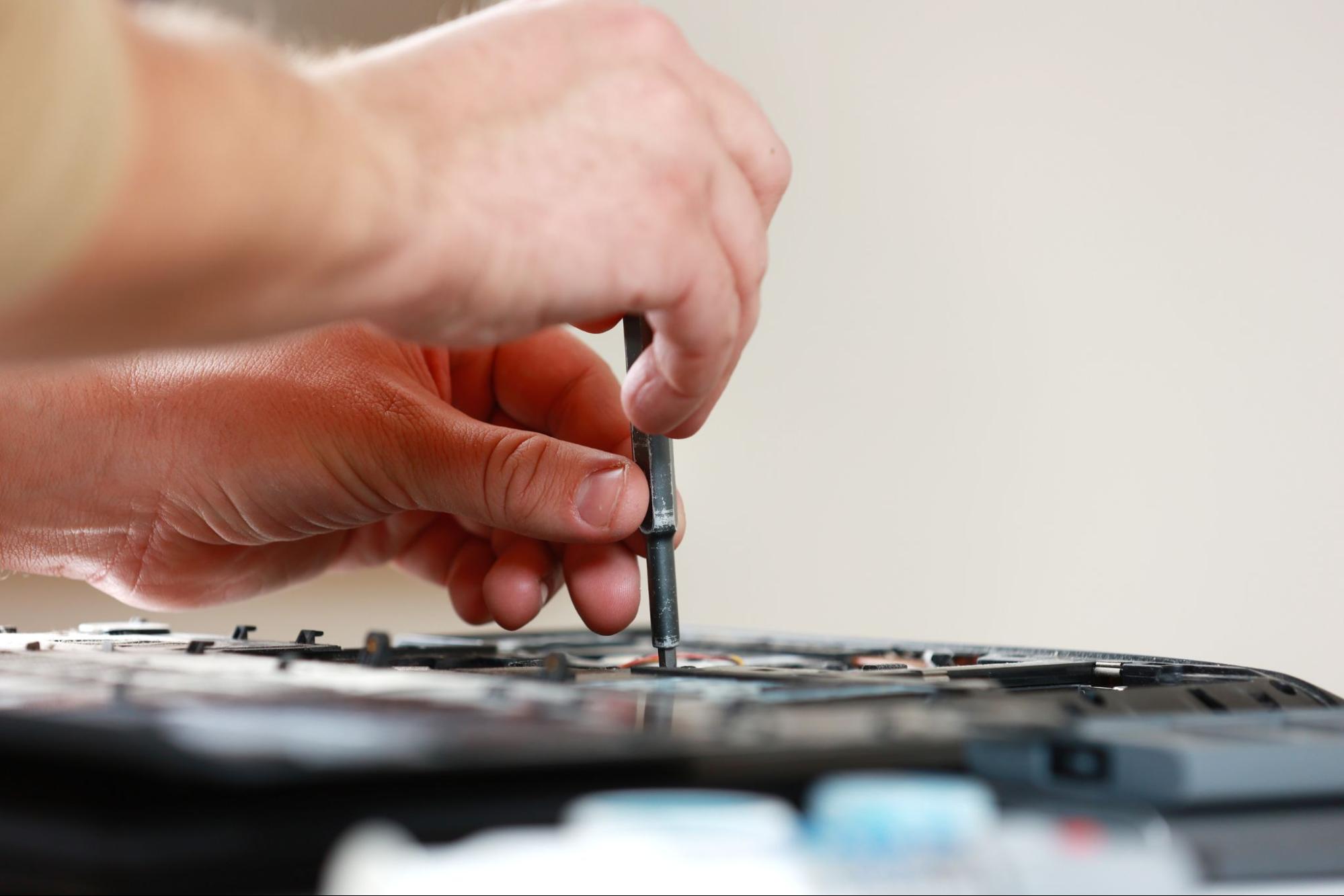 A close-up view of a MacBook keyboard replacement in progress.